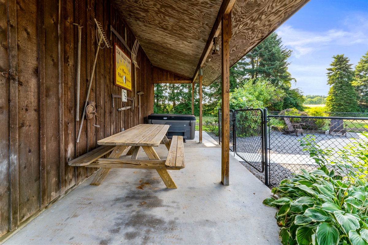 Gather with friends and family at the covered picnic table, just steps from the relaxing hot tub and pool.