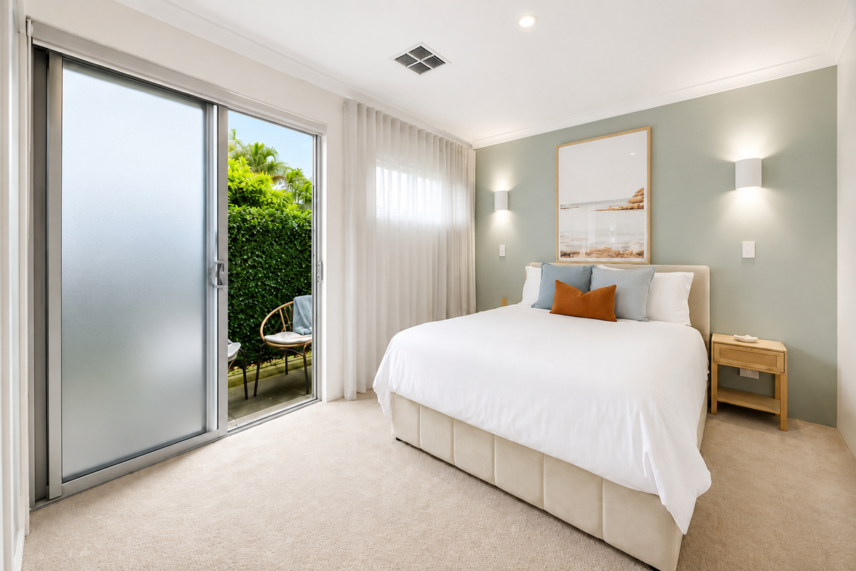 The main bedroom at The Duchess of Duke includes a queen bed, built-in robe storage and an attached ensuite bathroom within the single-level layout.