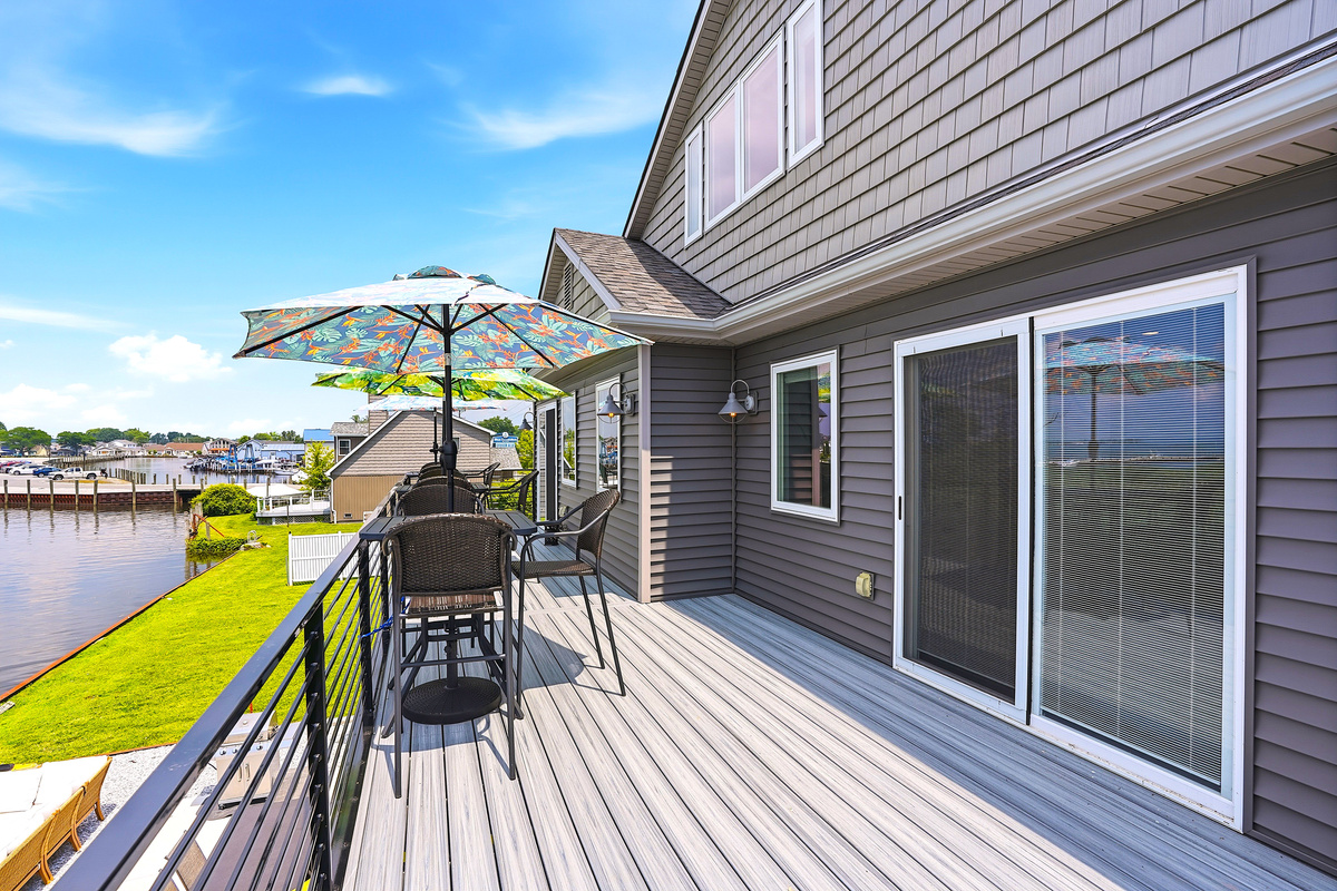 Accessible directly from the primary suite, the expansive balcony extends your living space outdoors, creating a serene setting for relaxing, dining, and making unforgettable waterfront memories.