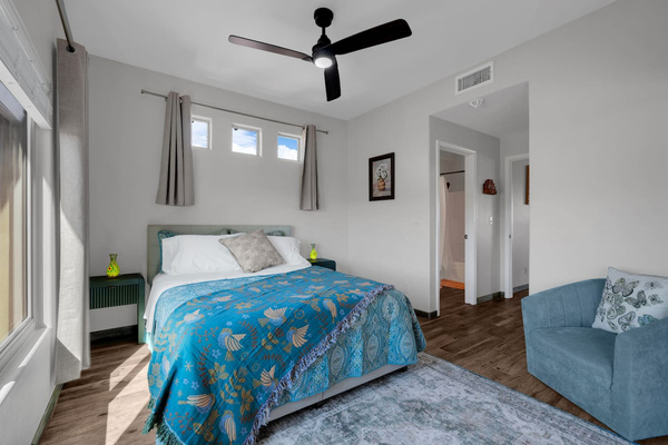Luxurious queen bedroom with stunning mountain views, smart-TV, and work desk.