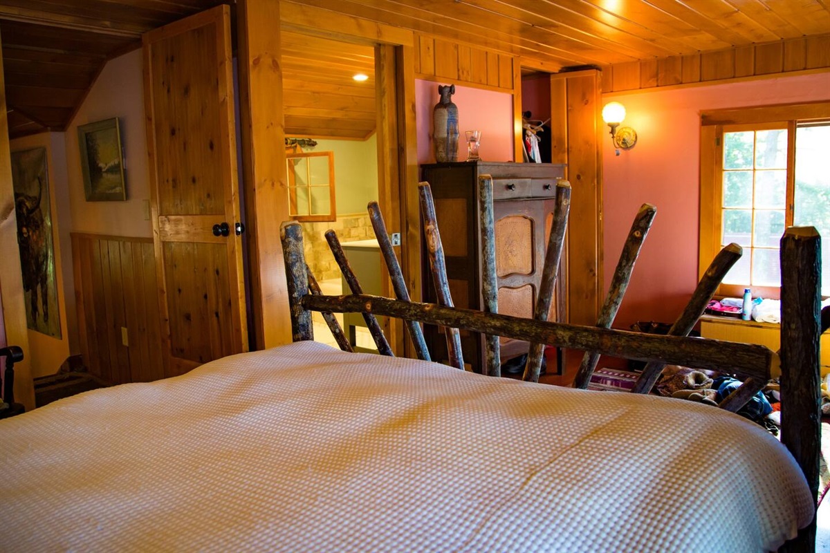 Primary bedroom with queen size bed. Bright and airy room with lake views and en suite bathroom attached.