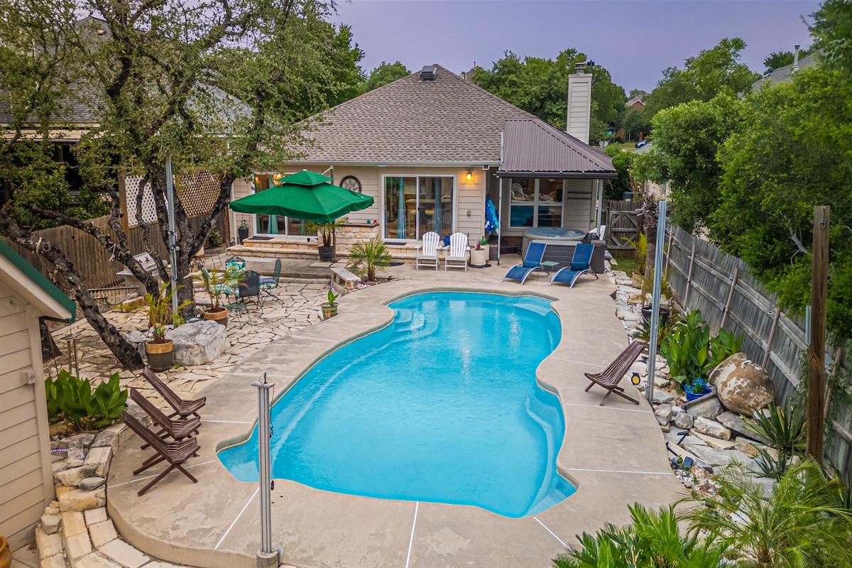 Welcome to your own private Backyard Oasis. Spa jets in pool bench seats & separate hot tub. Natural gas grill, oversized hammock for two, heated pool. Could it get any better?! Come, dive in ️