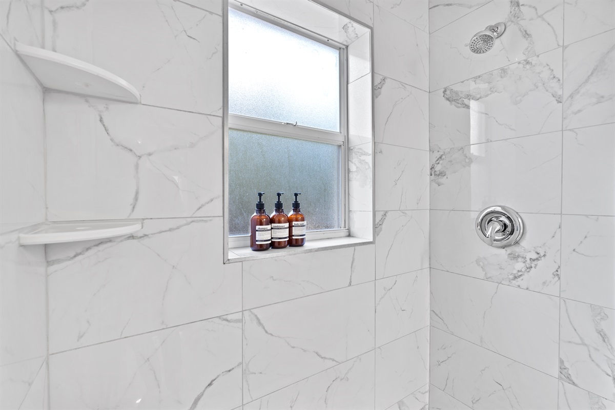 Refresh and recharge in a sleek coastal shower designed with luxury in mind.