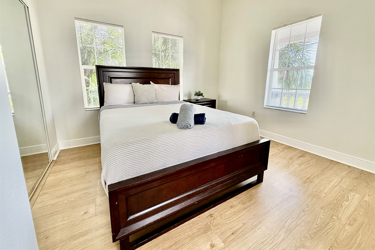 With a rich wood headboard and minimalist touches, this stylish bedroom balances modern simplicity with total comfort.