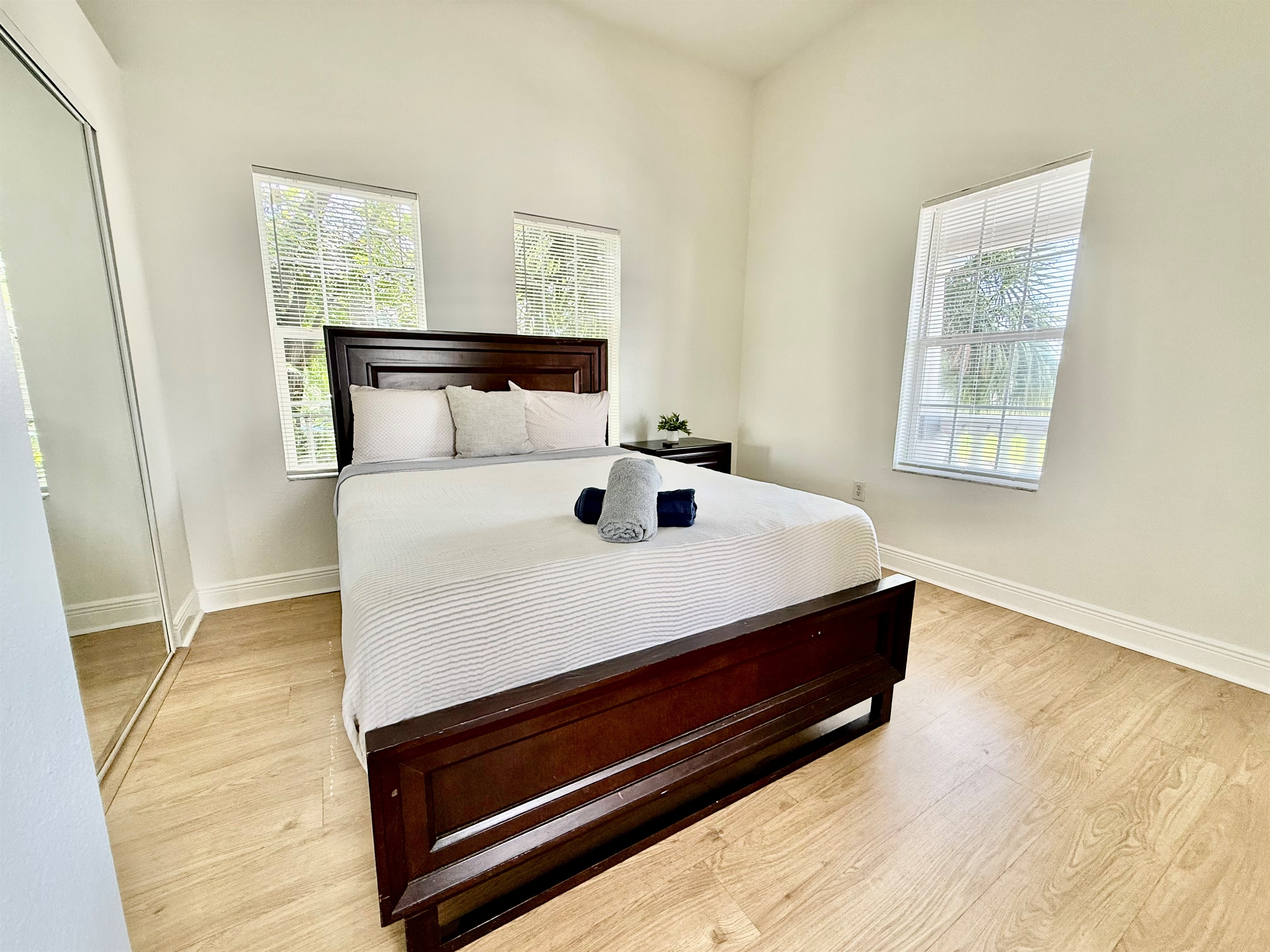 With a rich wood headboard and minimalist touches, this stylish bedroom balances modern simplicity with total comfort.