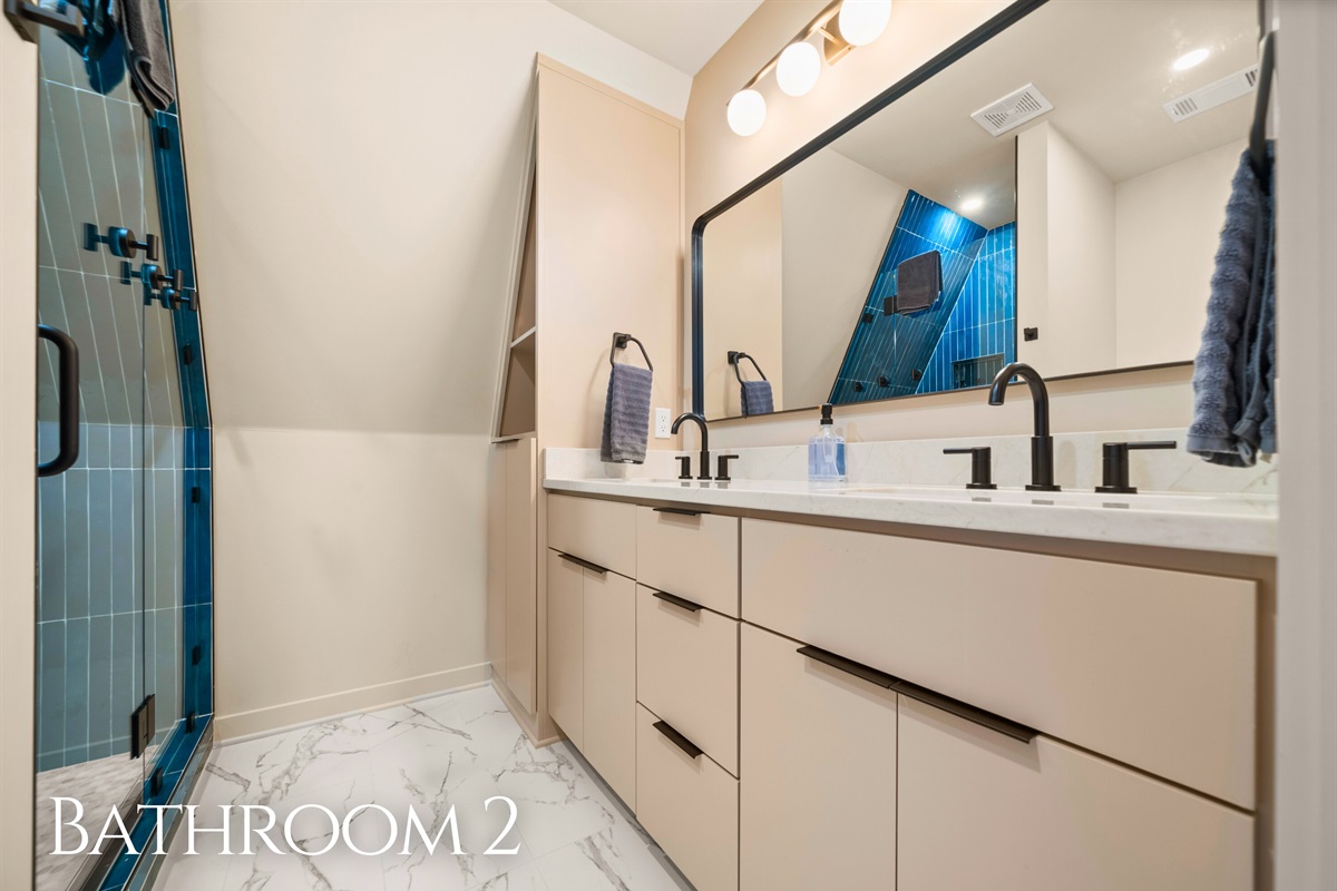 This bathroom keeps things sleek and simple, with a spacious vanity area that gives you plenty of room to get ready without feeling cramped.