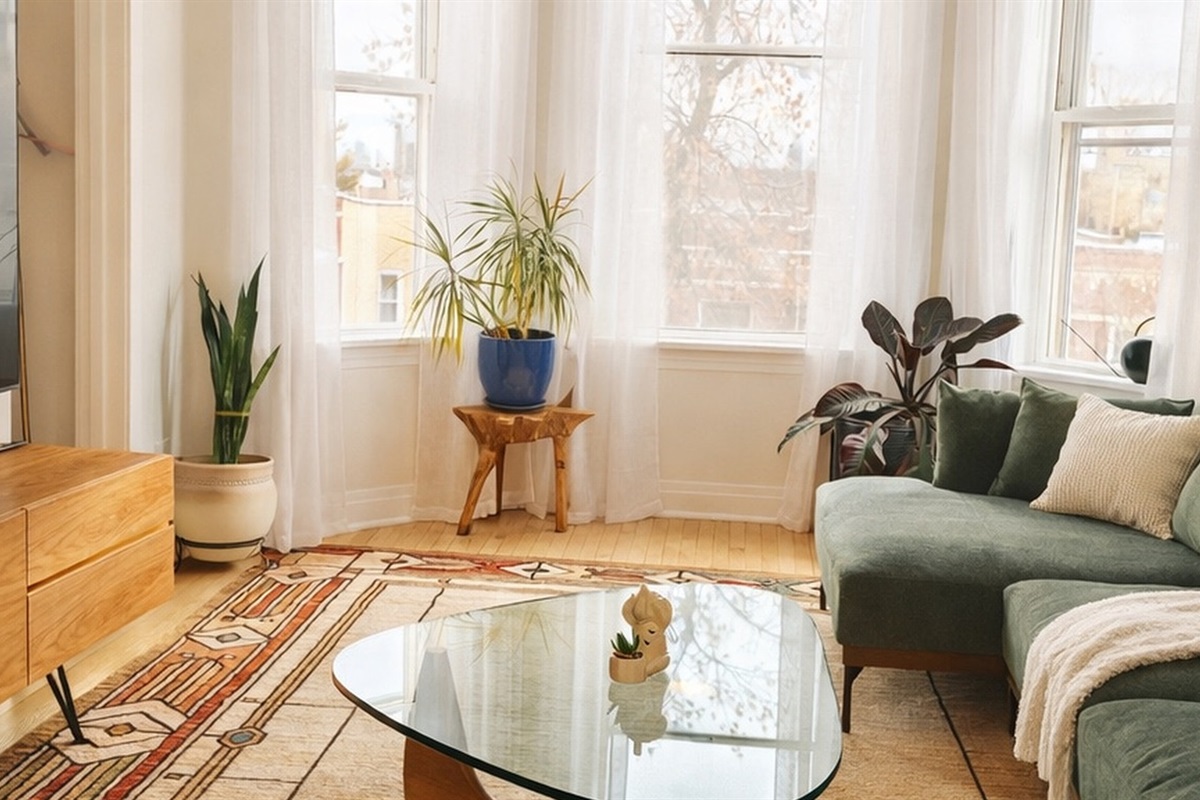 Bright and stylish living room with large windows, comfortable seating, and modern decor.