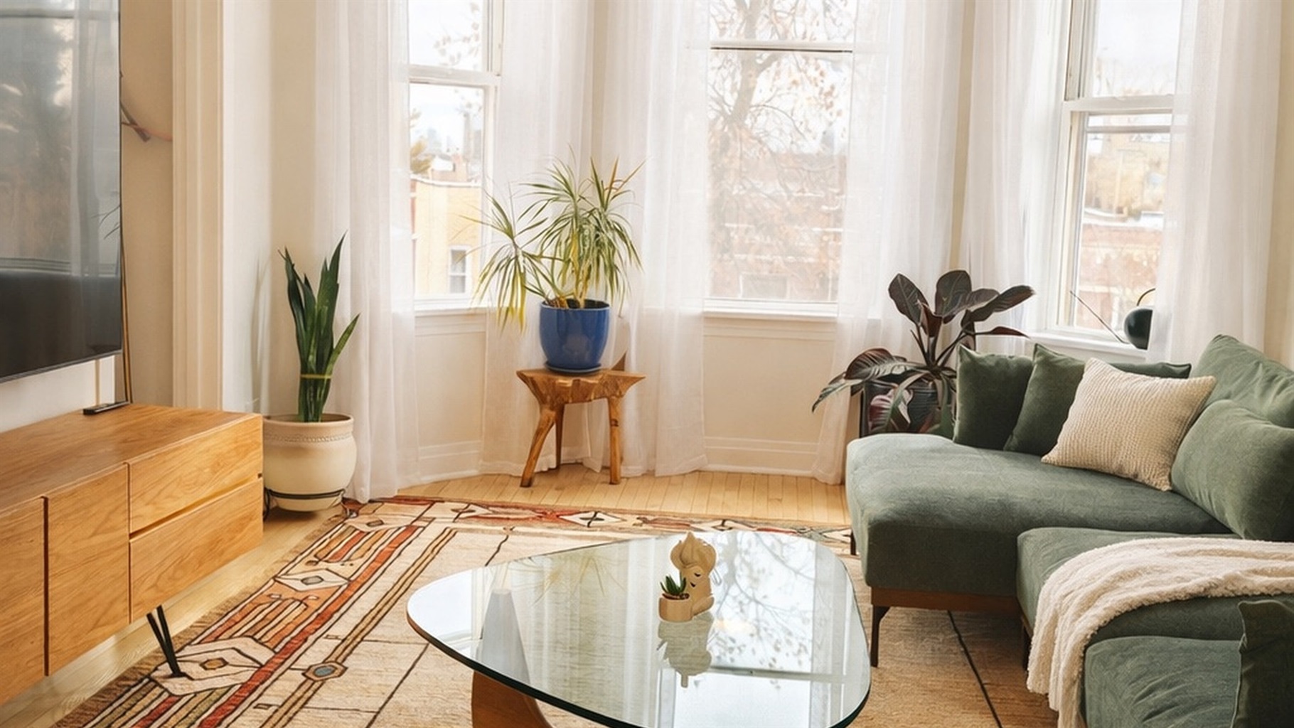 Bright and stylish living room with large windows, comfortable seating, and modern decor.