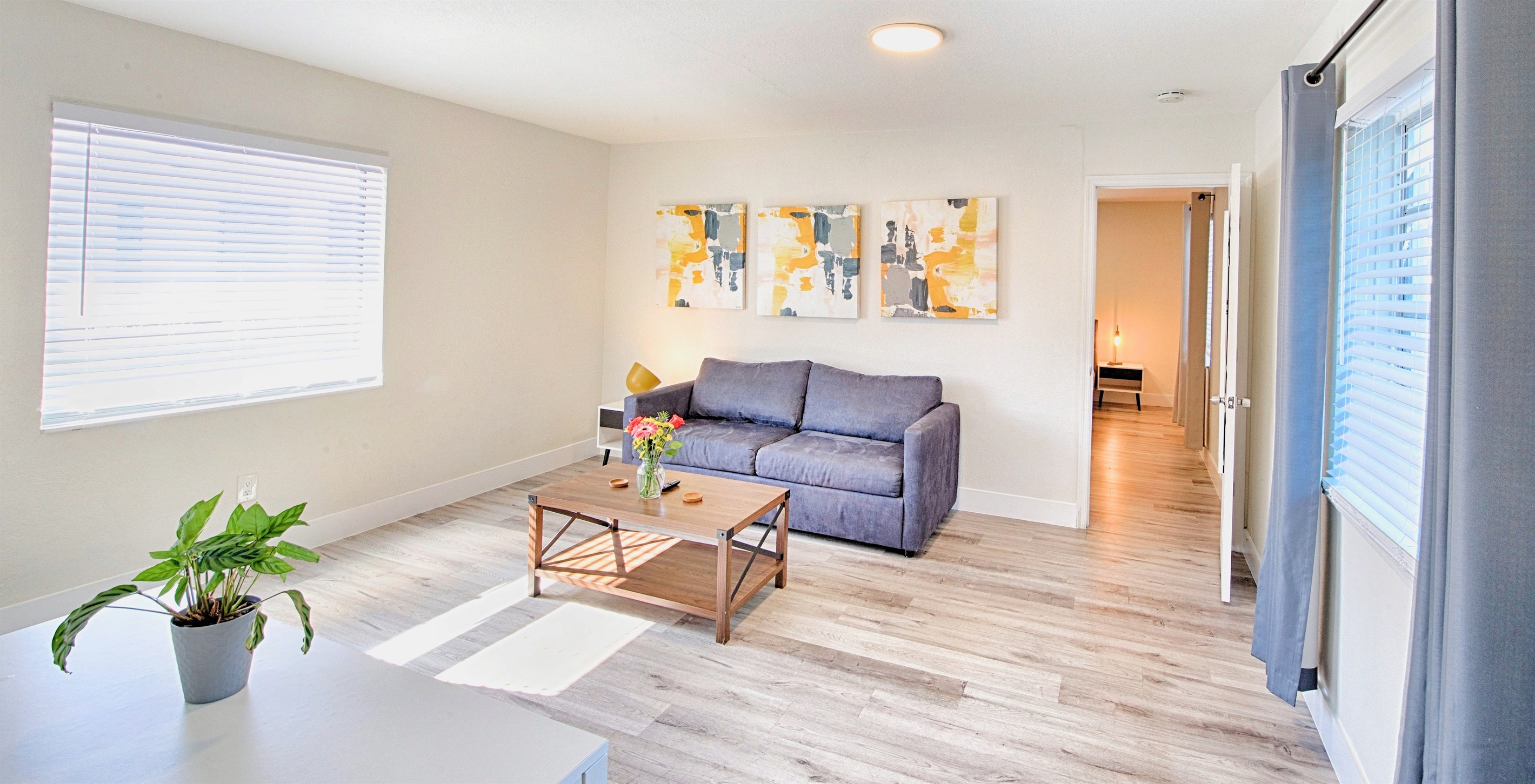 Your bright sunny living room with pool deck just outside.