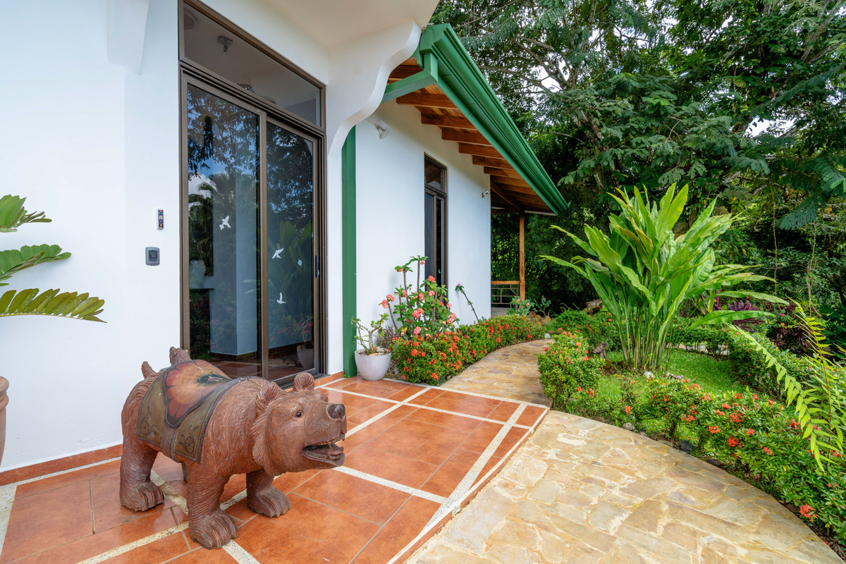 Villa front entrance with tropical garden and sculptural welcome detail