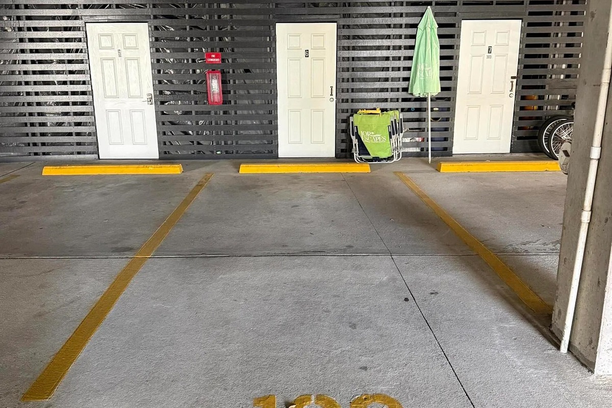 1 of 2 parking spaces with storage locker.  Guests staying 3 nights or more receive a beach gear credit (items pictured) | 1006 Ocean Blvd, Isle of Palms, SC | 102 Dunescape | IOP Escapes