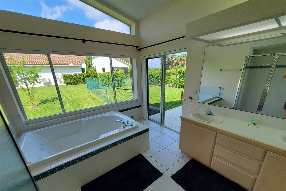 2nd King private bathroom with 2 sinks, walk in shower and sunk-in tub