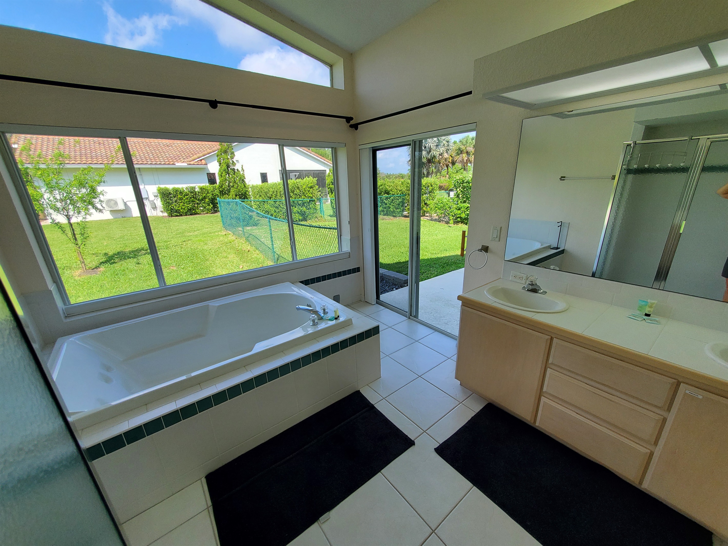 2nd King private bathroom with 2 sinks, walk in shower and sunk-in tub