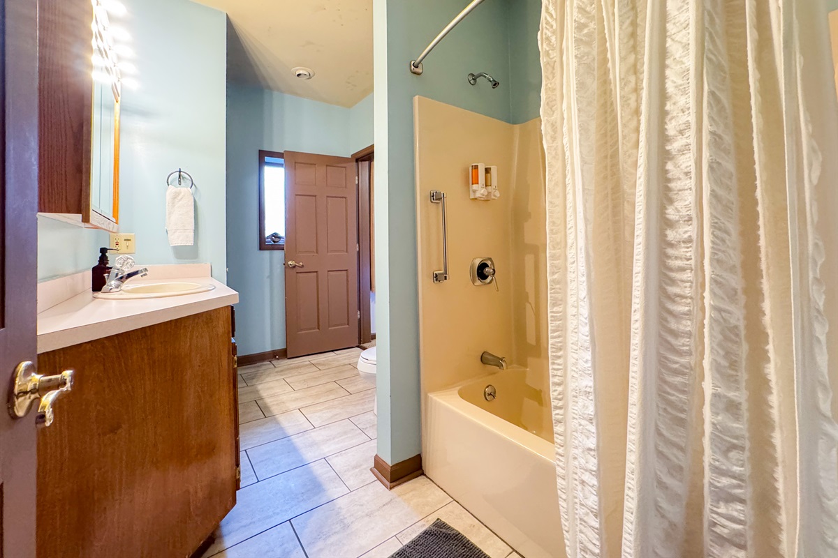 Full bathroom with tub/shower combination.