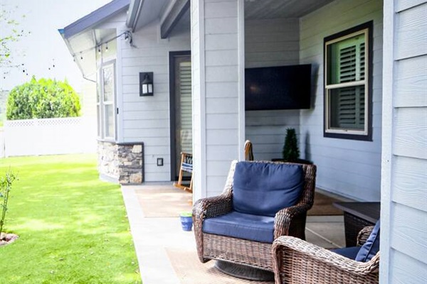 patio space with swivel rockers, rocking chairs, and fire pit, with direct view of Payson Golf Course