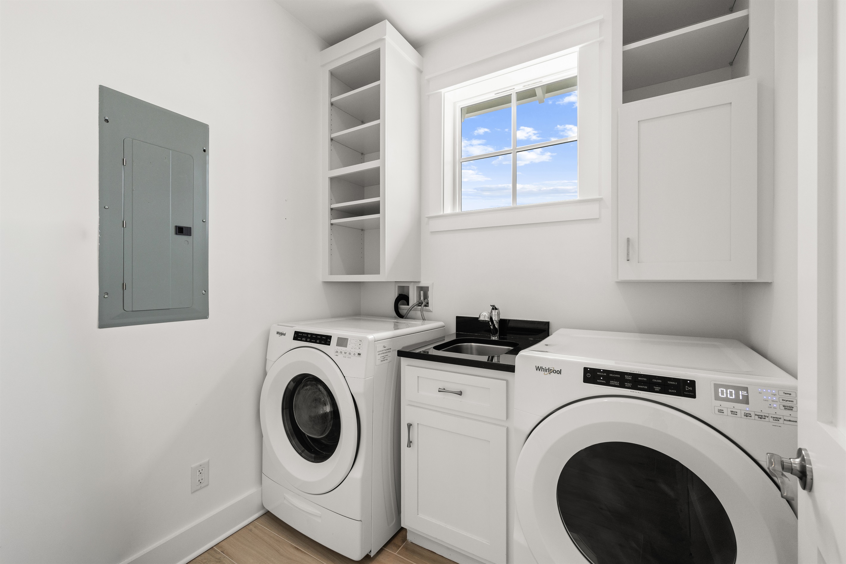 Laundry room with full-size washer and dryer makes it easy to keep beach towels, swimsuits, and vacation essentials fresh throughout your stay.