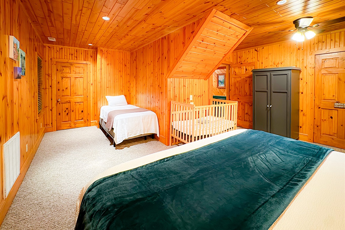 large bedroom one the lower level with a king bed, crib/pack-n-play, twin bed