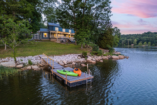 Golden hour settles over the private dock, kayaks ready for the morning ahead.