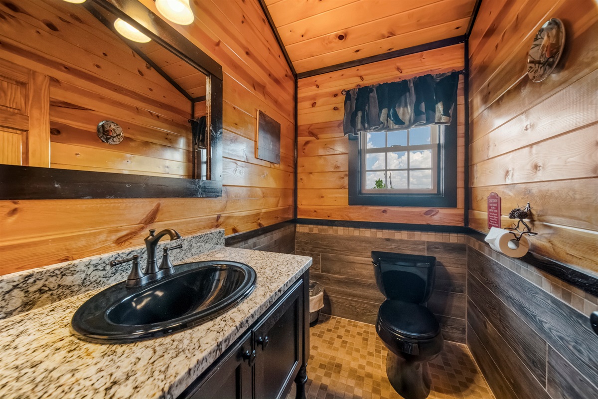 The convenient half bath is in the Great Room. Right in the middle of all of the action. It just has a toilet and sink, but it keeps your guests from using the master bath or having to run up and down the stairs to the big bathroom.