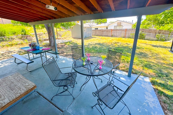 Your private backyard escape with cozy seating, a dining table, and a projector for ultimate relaxation!