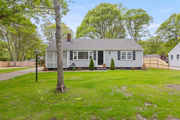Pull up to a spacious driveway, framed by a lush green lawn for a welcoming arrival!