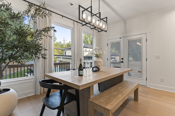 Gather around the large dining table with views of the pool and back yard. 
