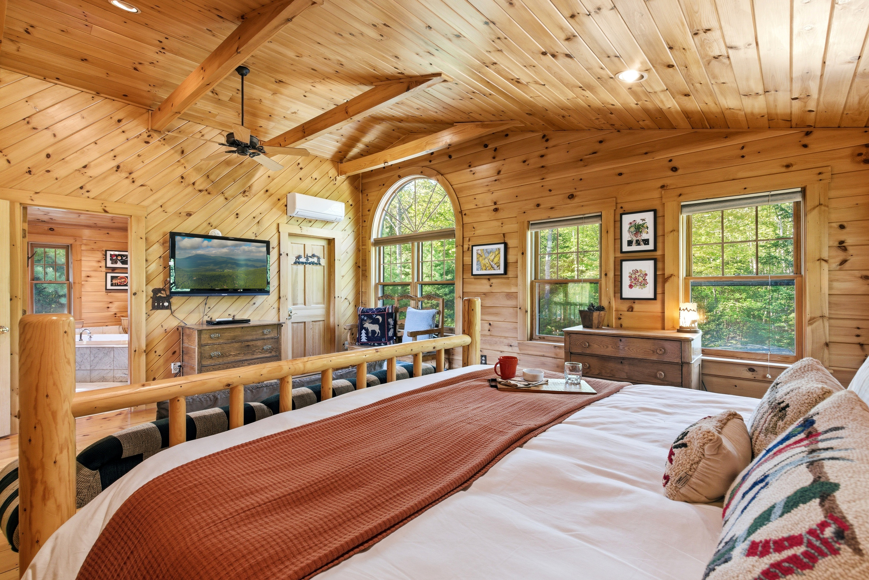 Enjoy elevated views of the cabin's open-concept living space from the cozy loft retreat.