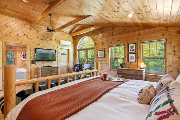 Enjoy elevated views of the cabin's open-concept living space from the cozy loft retreat.
