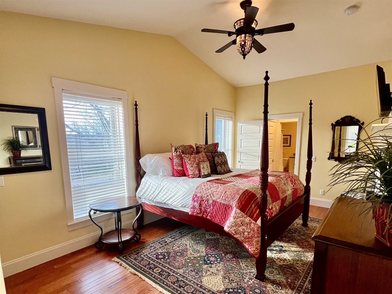 King-size bed with vibrant textiles and artistic accents.