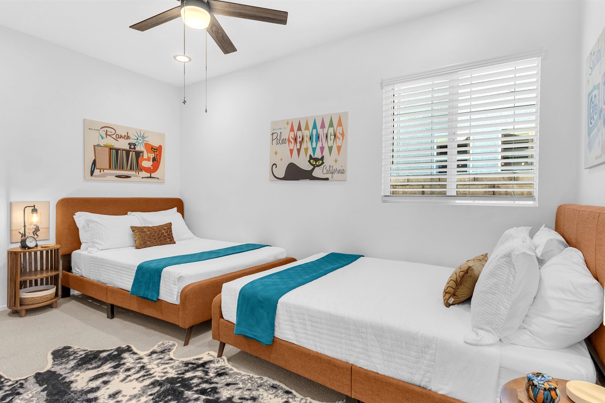 Playful guest room styled with warm desert tones and modern art—perfect for friends or kids