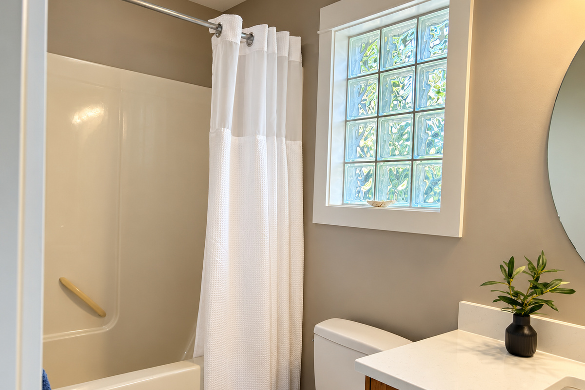 Full upstairs bathroom with both a bathtub and shower.