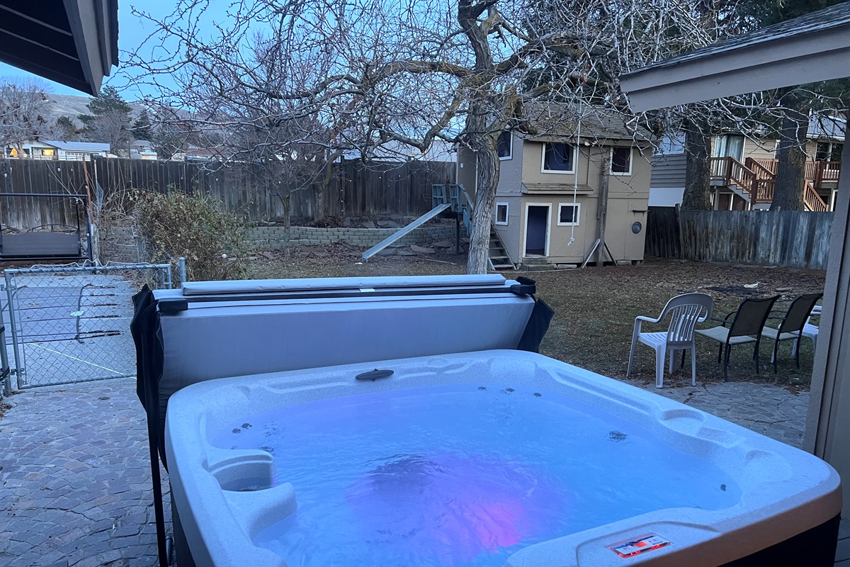 Enjoy the hot tub in the private backyard