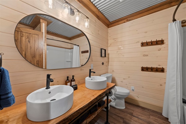 Lower Level Bathroom with Dual Vanity, Tub/Shower Combo, and In-Unit Washer & Dryer.