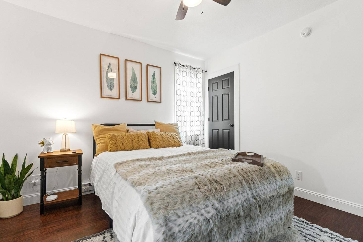 Step into a charming bedroom designed for comfort and relaxation. Thoughtfully decorated with stylish accents, it features warm lighting that creates a calming ambiance and plush, comfy pillows to ensure a perfect night's rest. 