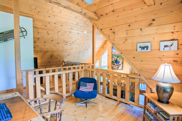The mezzanine also offers a fully-functional work space. Monitor, keyboard, mouse, and fast wifi. Bonus: your zoom background will be the massive cathedral ceiling of the family room