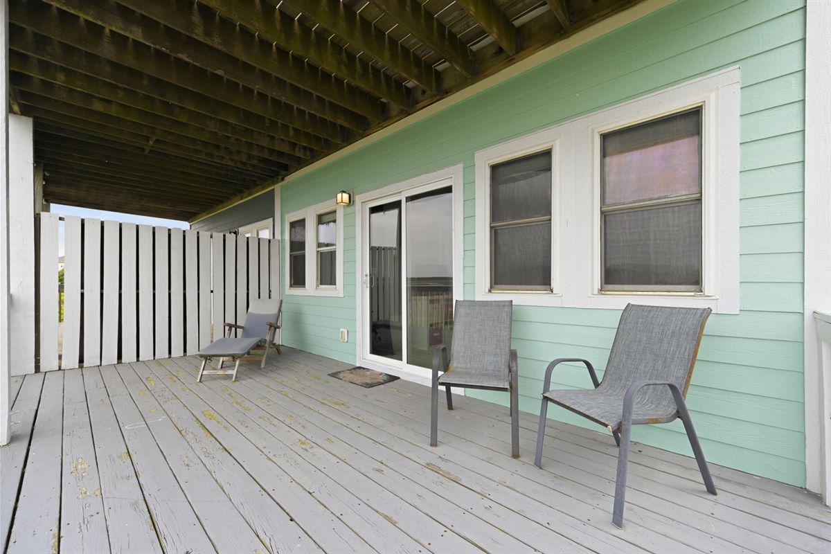 Spacious covered deck with seating and shaded outdoor area