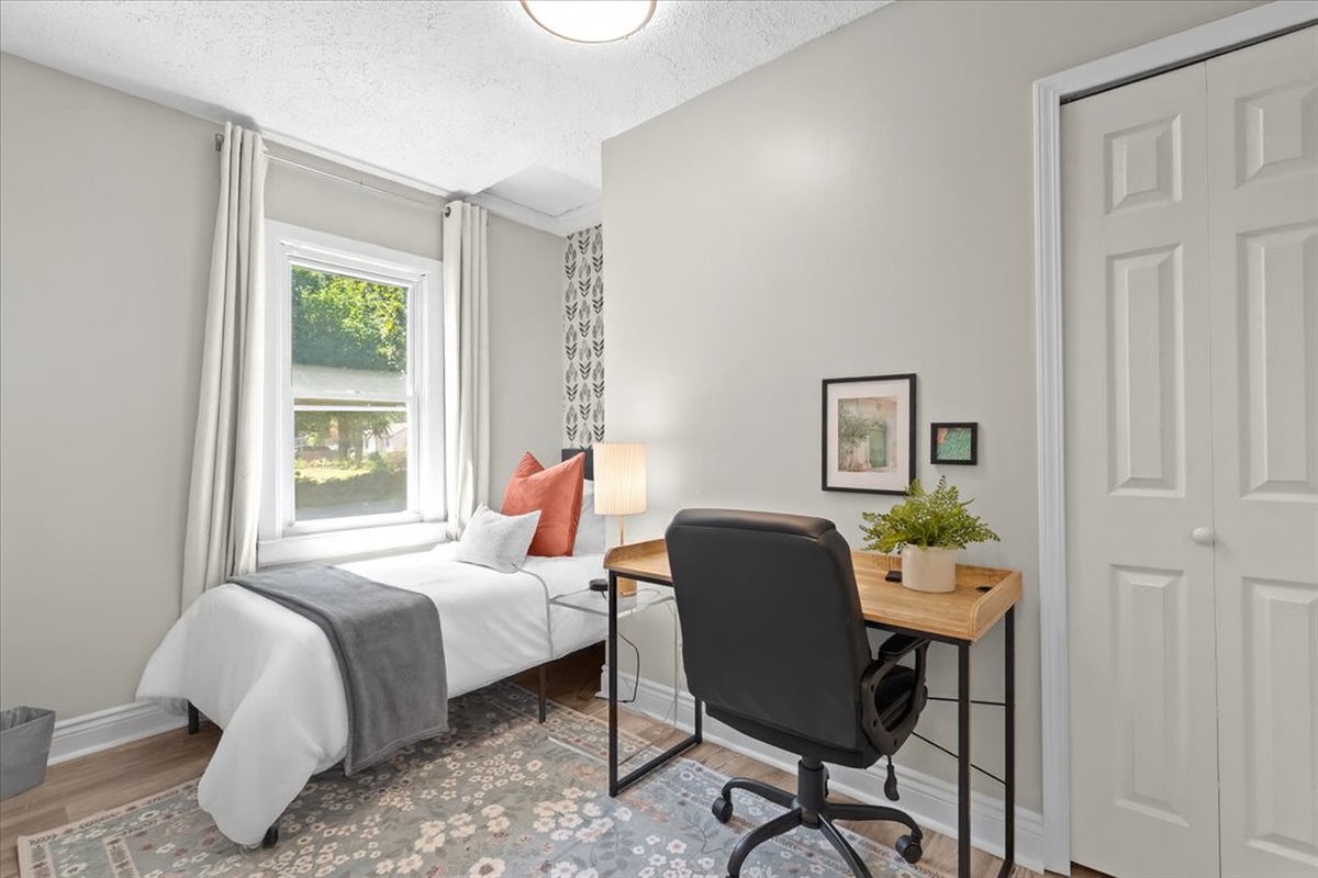 Bedroom with twin bed and workspace, ideal for kids or remote work