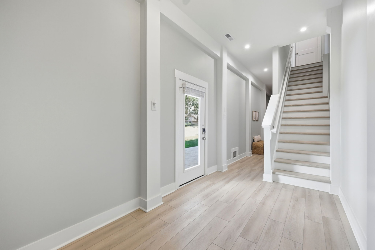 The spacious first-floor hallway offers easy access to the elevator, staircase, and main entrance for effortless arrivals and departures