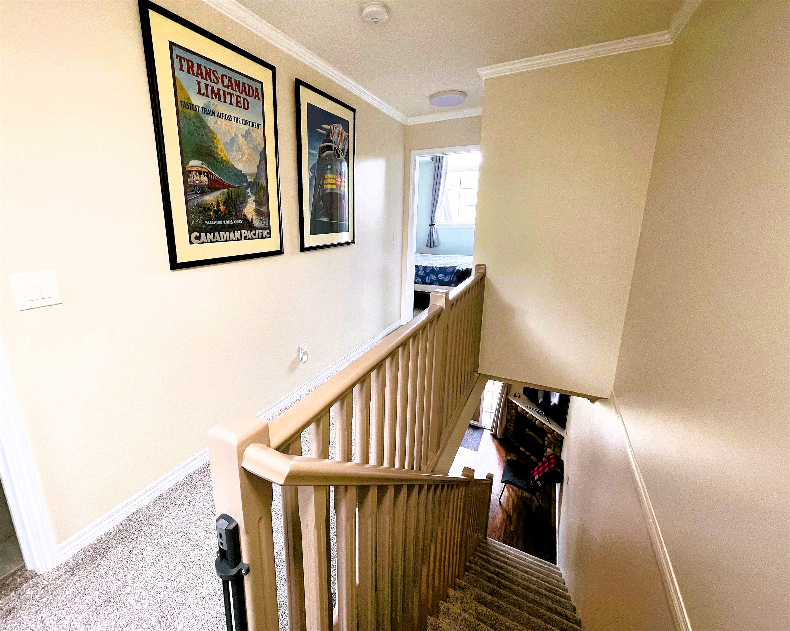 2 bedrooms, and 2 bathrooms on upper floor. Long hallway separates out the the two bedrooms. You can see the guest bedroom on the far side, and entrance to the guest bathroom on the right. There is a stairway, with an optional child gate at the top.