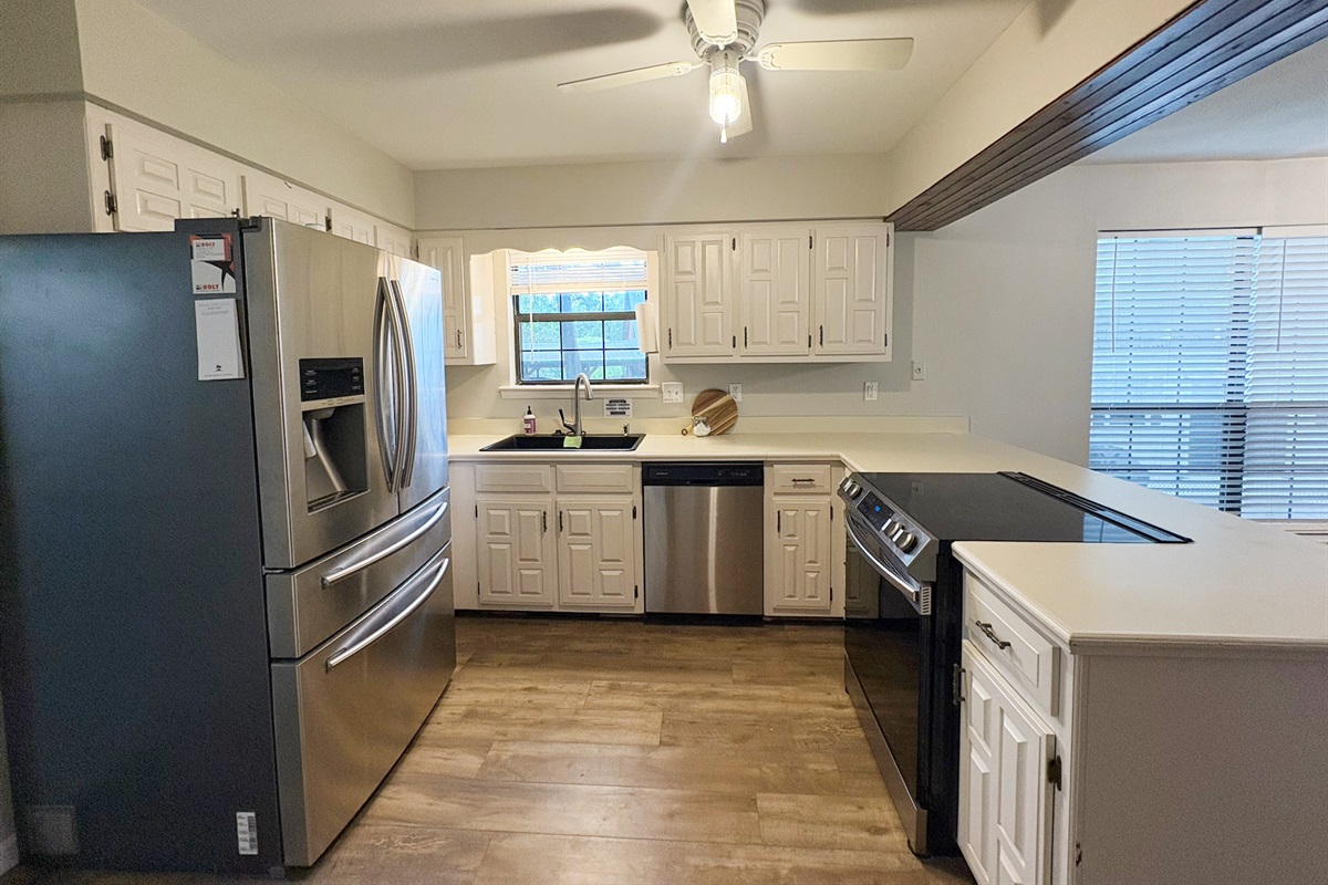 Kitchen is equipped with a Fridge, Dishwasher, and Electric Stove