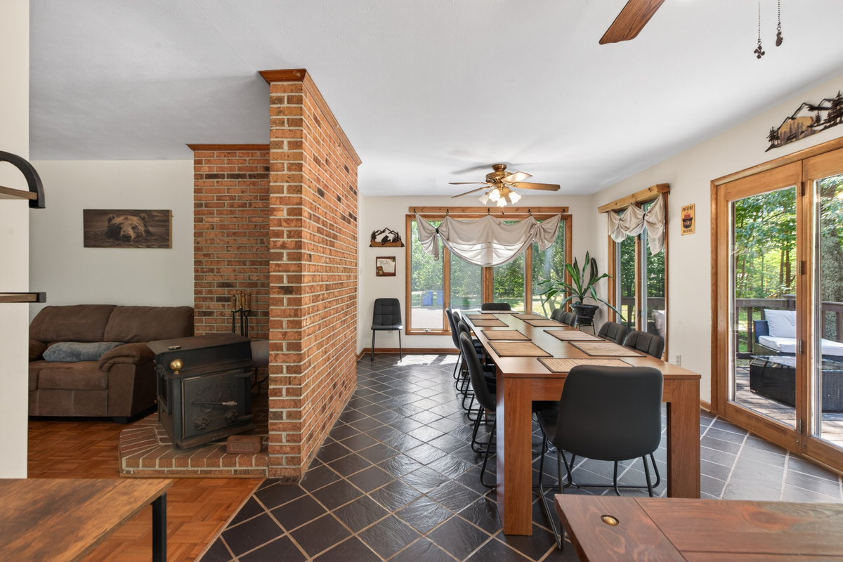 Dining Room: Gather around the wooden table under warm lighting, surrounded by nature's beauty!