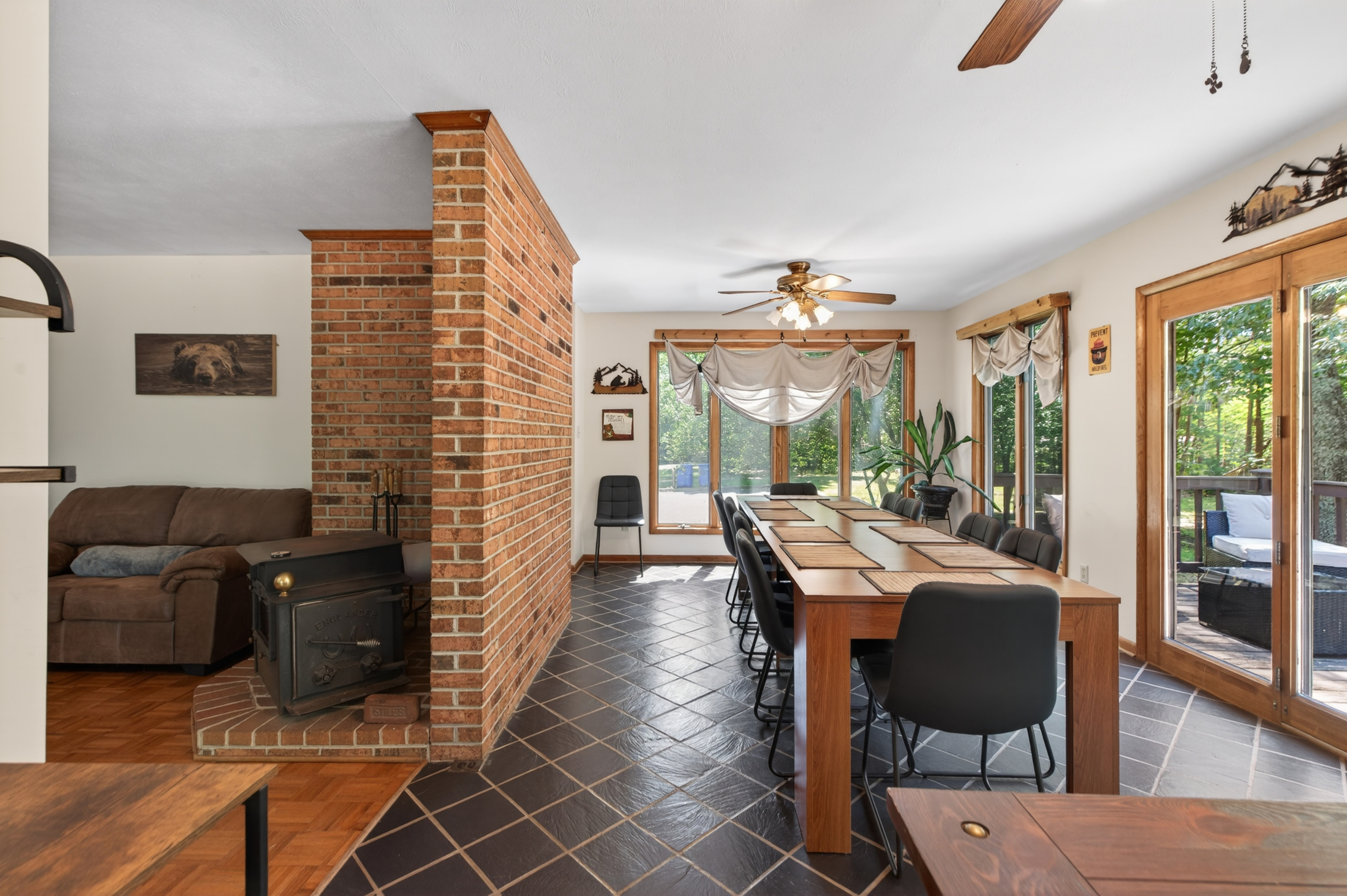 Dining Room: Gather around the wooden table under warm lighting, surrounded by nature's beauty!