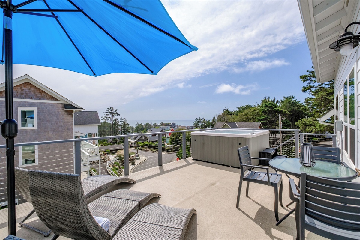 A spacious upper deck with seating and coastal views—perfect for morning coffee or sunset conversations. 