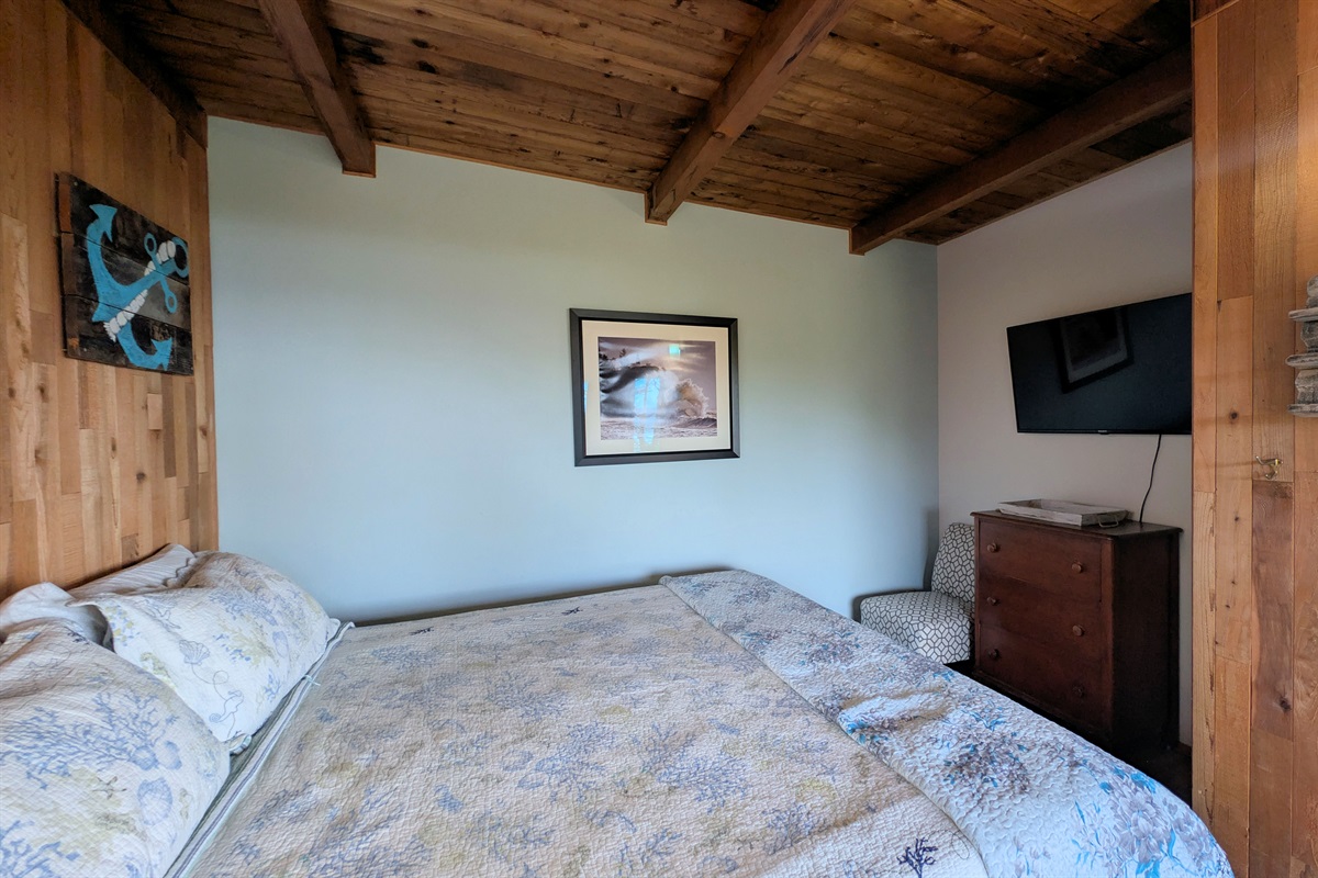 King bedroom off of living room with tV