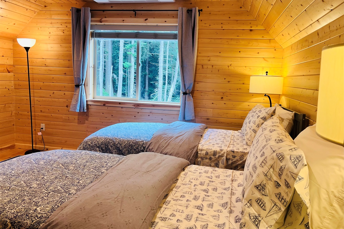 Pine paneling in this twin room gives a warm cabin feel.