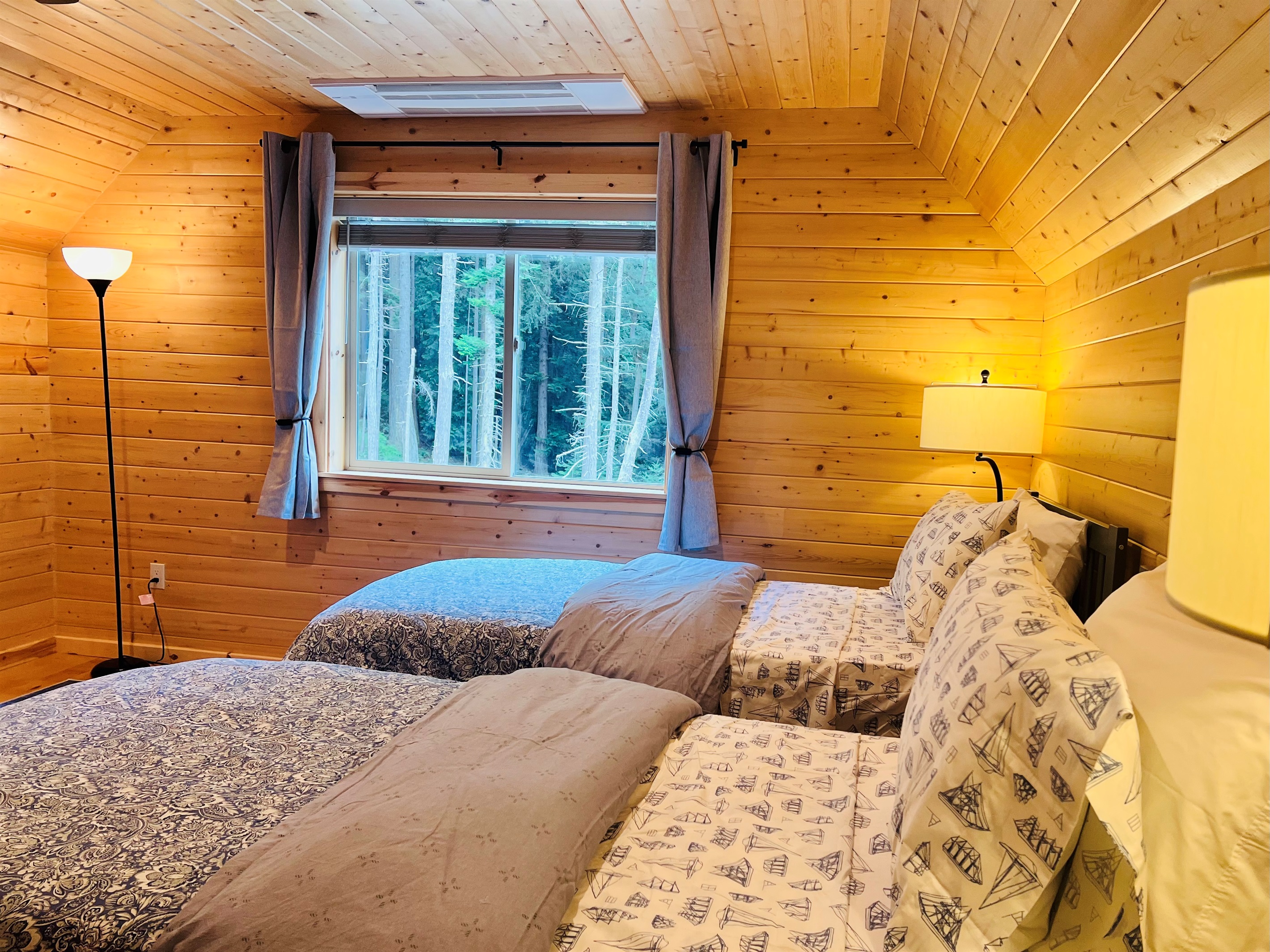 Pine paneling in this twin room gives a warm cabin feel.
