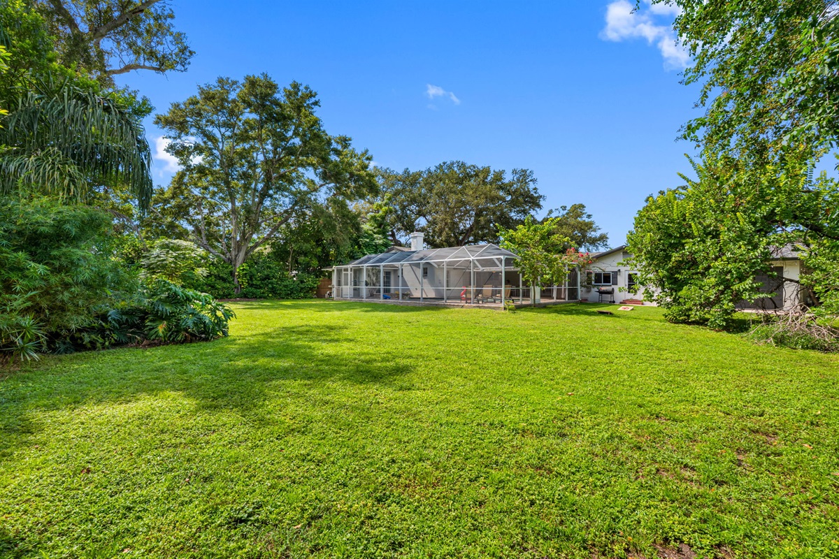 A private outdoor haven with mature landscaping and open green space, ideal for gardening or creating your own outdoor oasis.
