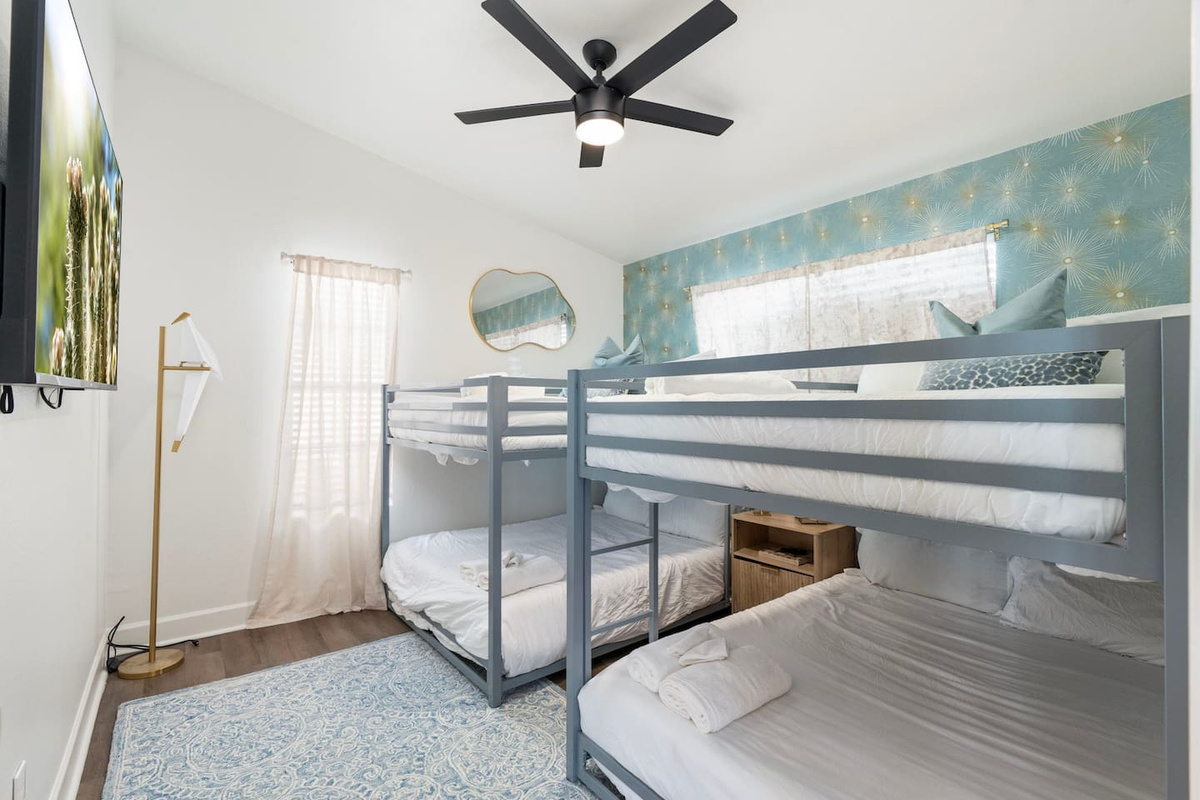 Bunk room with dual bunks, soft blue accent wall, and natural light—perfect for families or groups of friends.
