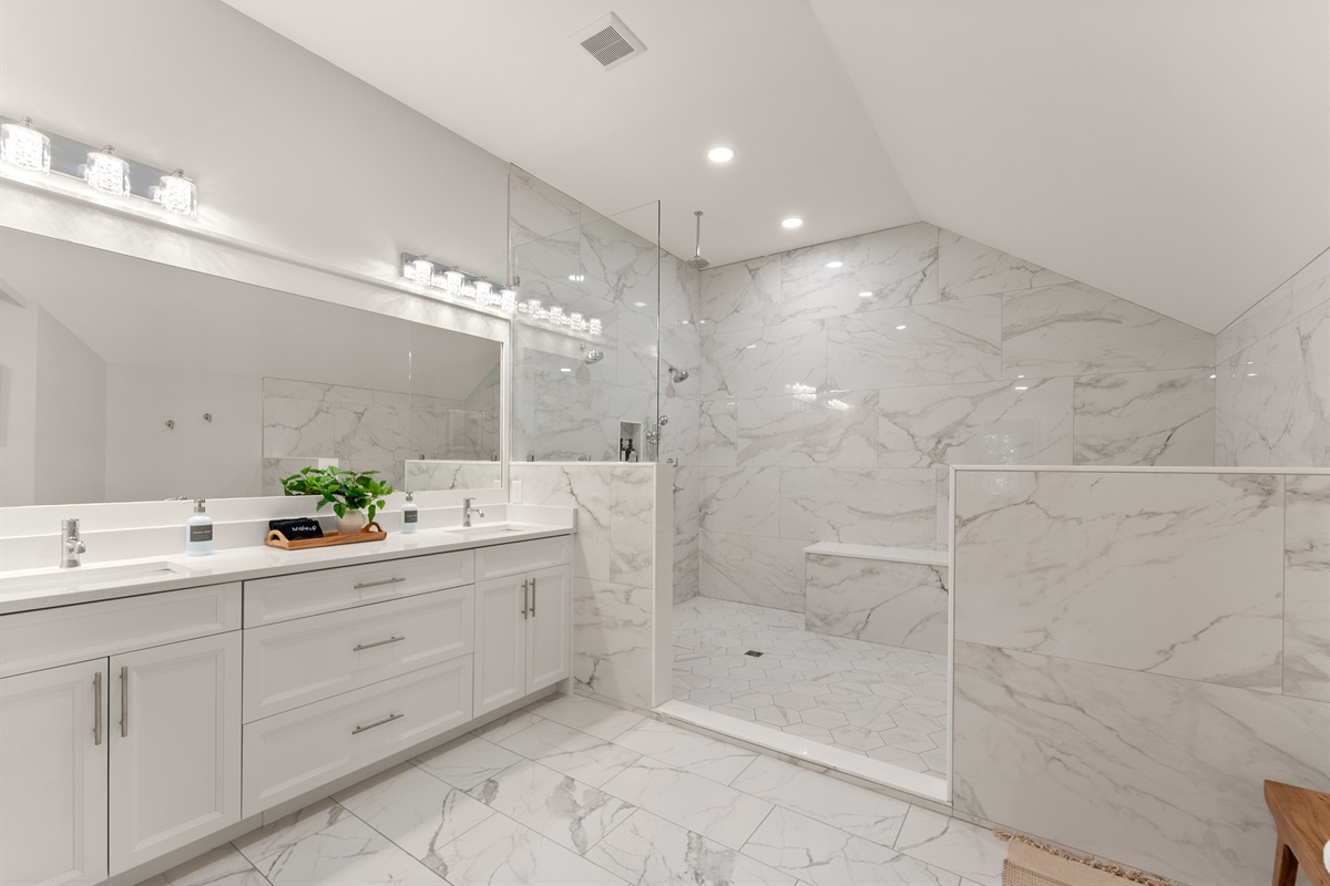 Spa-inspired primary bath with double vanity, and walk-in double shower.