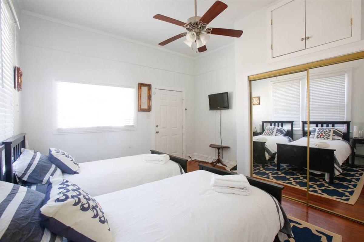 Twin bedroom.  Features a closet and cable tv. Accessible via an exterior door or the den.